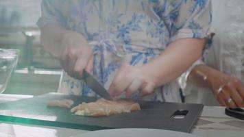 Woman Cutting Chicken Breast video