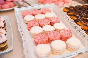 Delicious sweets arranged on the table for wedding reception photo