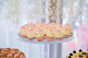 sweets and cookies arranged on the table for wedding reception photo