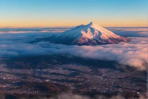 aerial landscape photo shot of a mountain from above, mist and snow