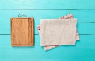 wooden empty cutting board and tablecloth on wooden background top view photo