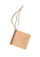 Brown paper square paper tag with a rope on a white isolated background photo