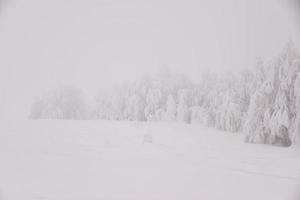 Winter snowy road in mountainous region after heavy snowfall in Romania photo