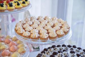 sweets and cookies arranged on the table for wedding reception photo