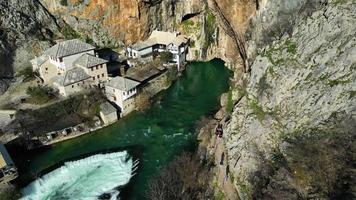 Aerial drone view of Tekija in Blagaj in BiH. The Tekija, dervish house, set at the source of the river Buna, was and still is a venue for dervish Zikr praise-chanting three nights weekly. video