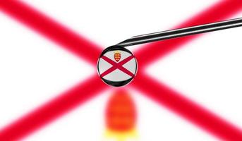 Vaccine syringe with drop on needle against national flag of Jersey background. Medical concept vaccination. Coronavirus Sars-Cov-2 pandemic protection. National safety idea. photo