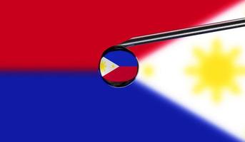 Vaccine syringe with drop on needle against national flag of Philippines background. Medical concept vaccination. Coronavirus Sars-Cov-2 pandemic protection. National safety idea. photo