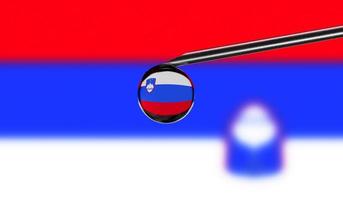 Vaccine syringe with drop on needle against national flag of Slovenia background. Medical concept vaccination. Coronavirus Sars-Cov-2 pandemic protection. National safety idea. photo