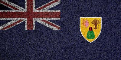 Flag of the British Overseas Territory of the Turks and Caicos Islands on a textured background. Concept collage. photo