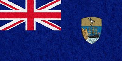 Flag of the British Overseas Territory of the Saint Helen Island on a textured background. Concept collage. photo