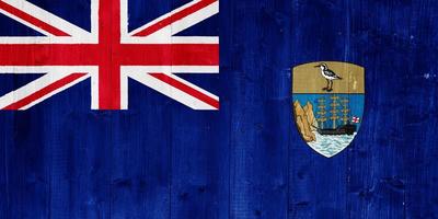 Flag of the British Overseas Territory of the Saint Helen Island on a textured background. Concept collage. photo