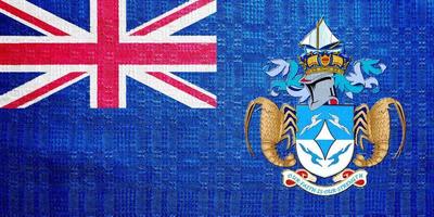 Flag of the British Overseas Territory of the Tristan da Cunha Island on a textured background. Concept collage. photo
