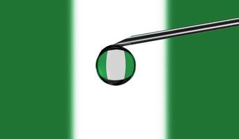 Vaccine syringe with drop on needle against national flag of Nigeria background. Medical concept vaccination. Coronavirus Sars-Cov-2 pandemic protection. National safety idea. photo