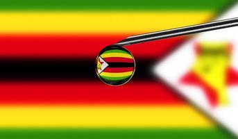 Vaccine syringe with drop on needle against national flag of Zimbabwe background. Medical concept vaccination. Coronavirus Sars-Cov-2 pandemic protection. National safety idea. photo