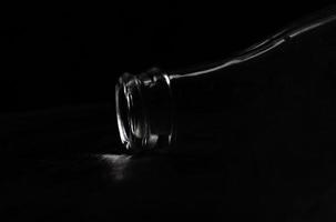The neck of a glass bottle on a black background. photo
