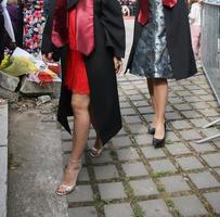 university graduating students are having a photo shooting in the park