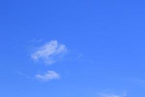 Clear blue sky and white clouds photo