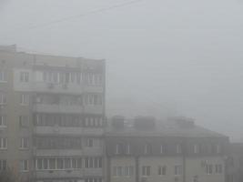 Morning winter fog hangs over the city photo