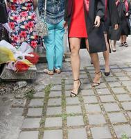 university graduating students are having a photo shooting in the park