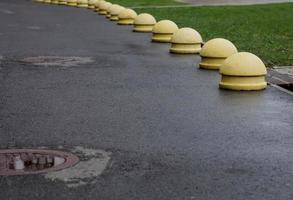 concrete balls attached to the paving or asphalt. photo