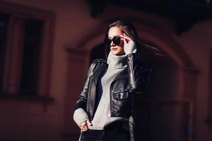 fashion brunette woman in leather jacket photo