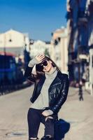 woman in sunglasses and leather jacket photo