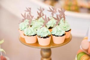 Delicious sweets arranged on the table for wedding reception photo