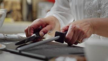 Woman Sharpening Knife With a Honing Tool video