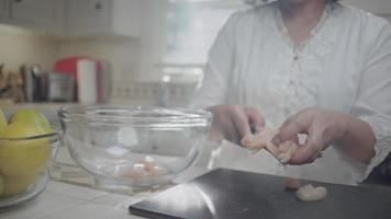Woman Placing Diced Chicken Breast in a Bowl video