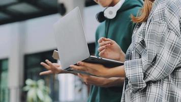 volle Konzentration bei der Arbeit. Gruppe junger Geschäftsleute, die zusammen mit im Hintergrund sitzenden Kollegen am Schreibtisch arbeiten und kommunizieren video