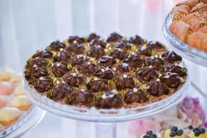 sweets and cookies arranged on the table for wedding reception photo