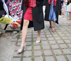 university graduating students are having a photo shooting in the park