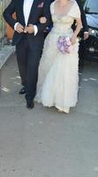 bride and groom walking on the street photo