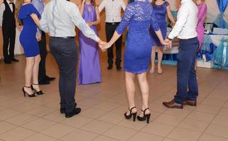 People dancing at the wedding party. focus on legs photo