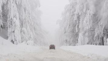 Winter snowy road in mountainous region after heavy snowfall in Romania photo
