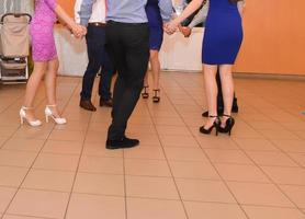 gente bailando en la fiesta de bodas. centrarse en las piernas foto