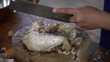 Asian woman's hand is cutting steamed chicken meat.Cooking ideas video