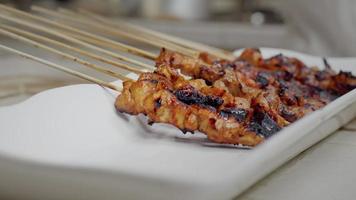 Placing Cooked Chicken Satay on a Plate video