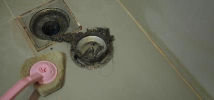 Drain cleaning Clogged and dirty sewer pipes floor drain. photo