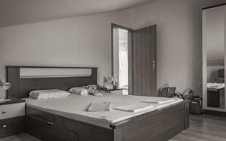 Simple white clean apartment hotel bedroom in Novi Vinodolski Croatia. photo