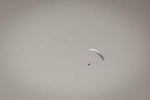 Colorful parachute aviator with blue sky. Paragliding photo