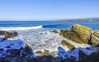 Beautiful rocks cliffs surfer waves at beach Puerto Escondido Mexico. photo