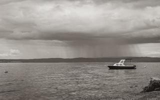 Huge rain clouds showers behind a boat Novi Vinodolski Croatia. photo