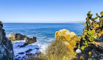 Beautiful rocks cliffs surfer waves at beach Puerto Escondido Mexico. photo