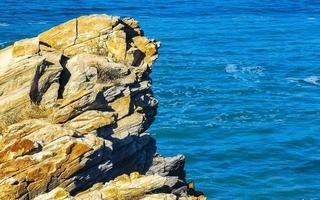 Beautiful rocks cliffs surfer waves at beach Puerto Escondido Mexico. photo