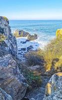 Beautiful rocks cliffs surfer waves at beach Puerto Escondido Mexico. photo