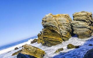 Beautiful rocks cliffs surfer waves at beach Puerto Escondido Mexico. photo