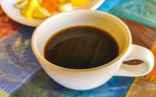 Coffee in cup on colorful tablecloth in Mazunte Mexico. photo