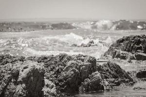 Strong waves, stones and sea cliffs, Sea Point promenade in Cape Town, South Africa. photo