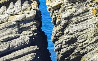 Beautiful rocks cliffs surfer waves at beach Puerto Escondido Mexico. photo